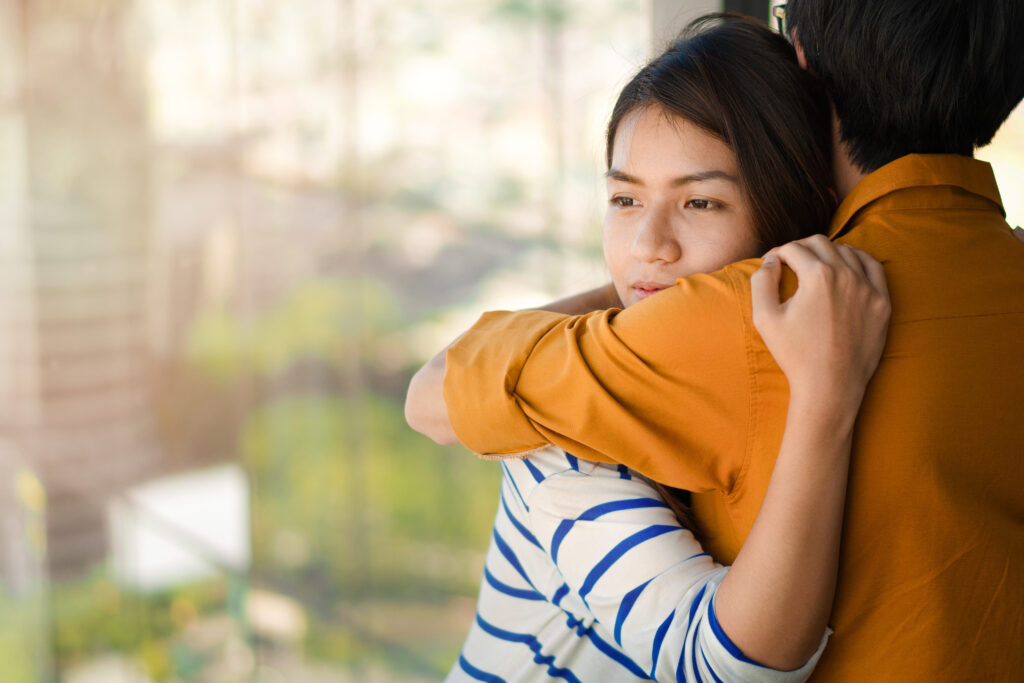 Young depressed asian woman hug her friend for encouragement, Selective focus, PTSD Mental health concept