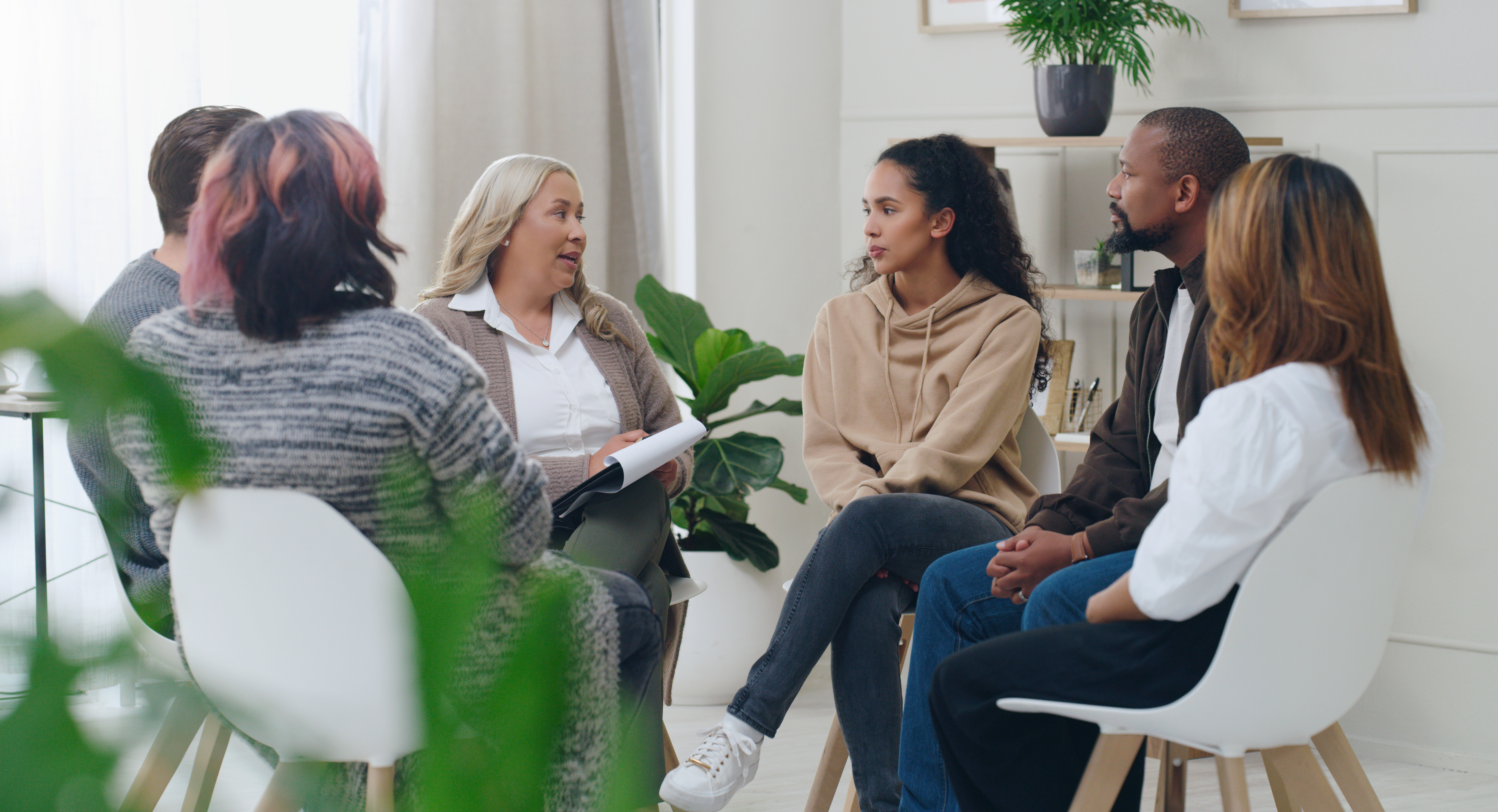 Diversity, mental health and group therapy counseling support meeting, healthy conversation and wellness. Psychology counselor, psychologist help people and talk about anxiety, depression or stress.