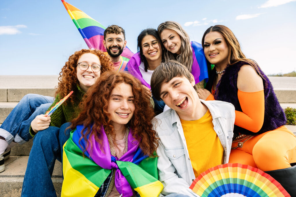 Diverse group of LGBT people having fun celebrating gay pride party festival day. LGBTQIA community concept